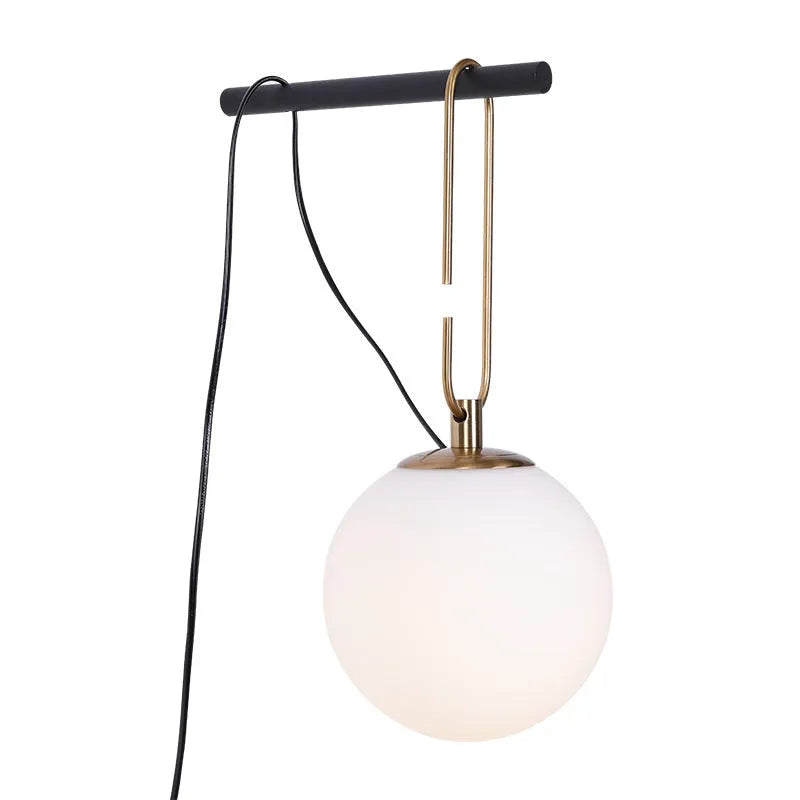 Nordic modern glass wall lamp mounted on a wall, showcasing its translucent design.