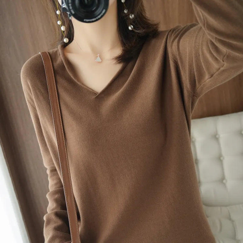 Women's V-neck long sleeve knitwear pullover top in a macaron colour on a hanger.