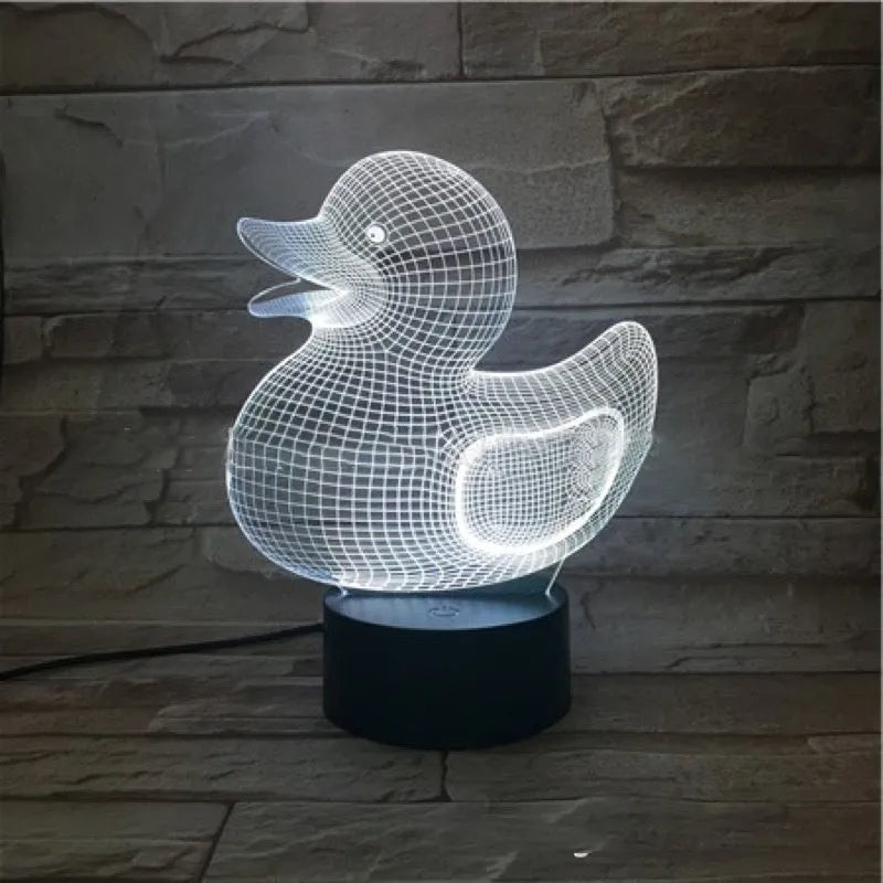 Little yellow duck 3D night light with multi-colour LED glow on an ABS base, showing remote control.