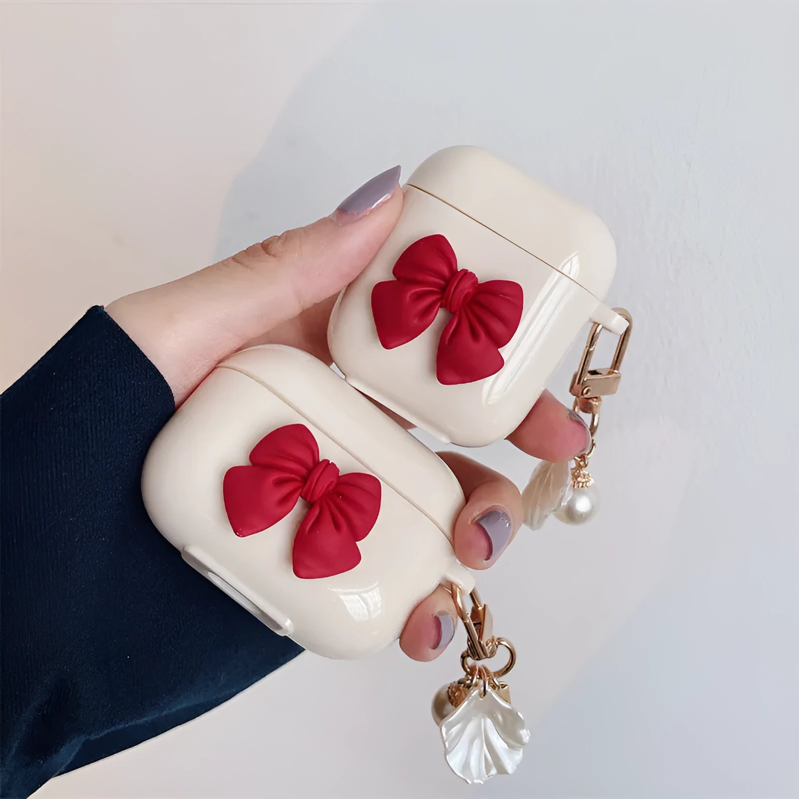 Beige and red bow shell design TPU silicone protective case for AirPods Pro charging case.