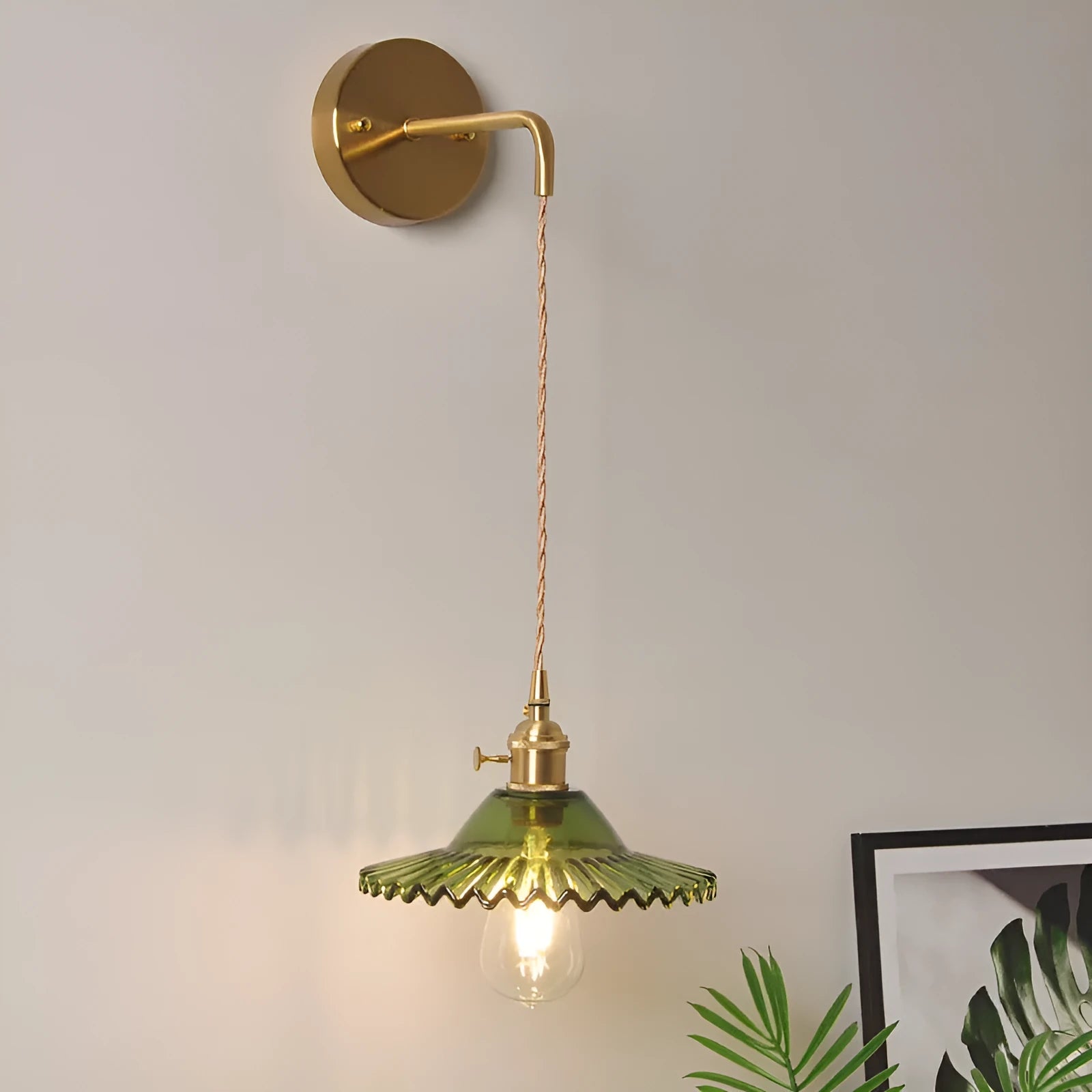Retro brass copper lotus wall lamp with a glass shade in one of six colours, shown beside a bed.