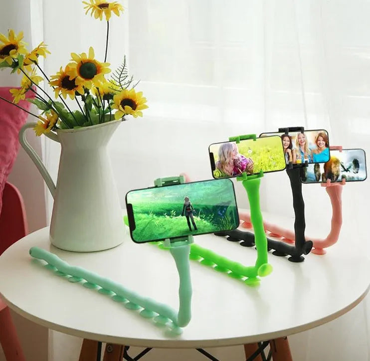 Black flexible worm arm phone holder with suction cup attached to a bicycle handlebar