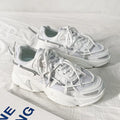 Men's platform dad shoes in black, white, or grey with a lace-up front and a thick sole.