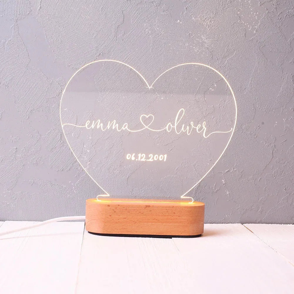 Custom engraved acrylic night light with LED base, showing personalised names and date.