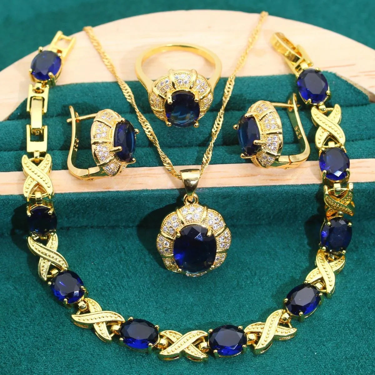 Gold-plated necklace, earrings, ring and bracelet set with blue cubic zirconia stones.