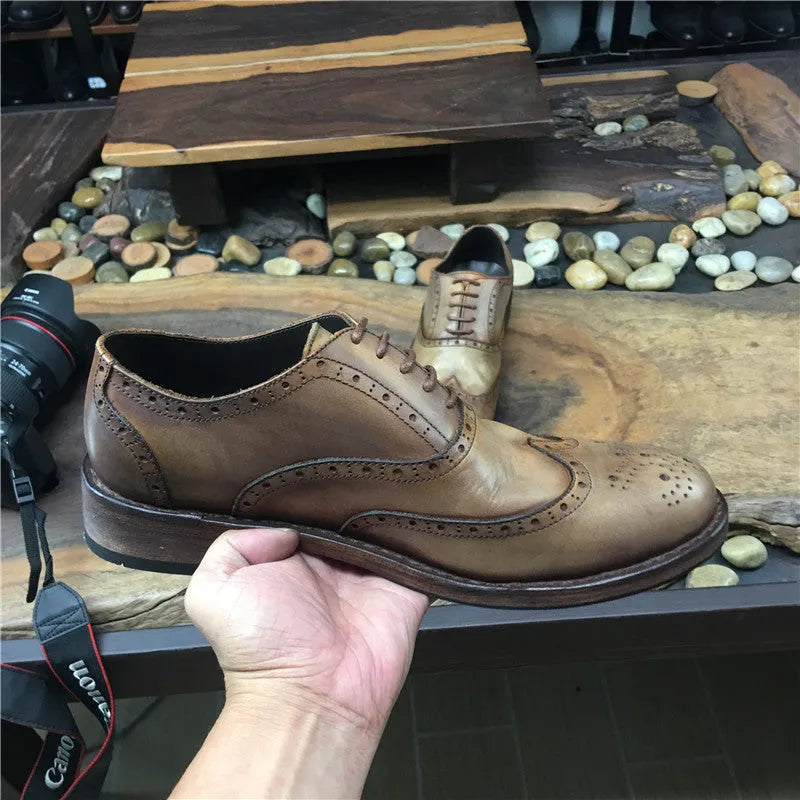 Light brown men's vintage distressed leather shoes with engraved detailing, round toe, and lace-up front.