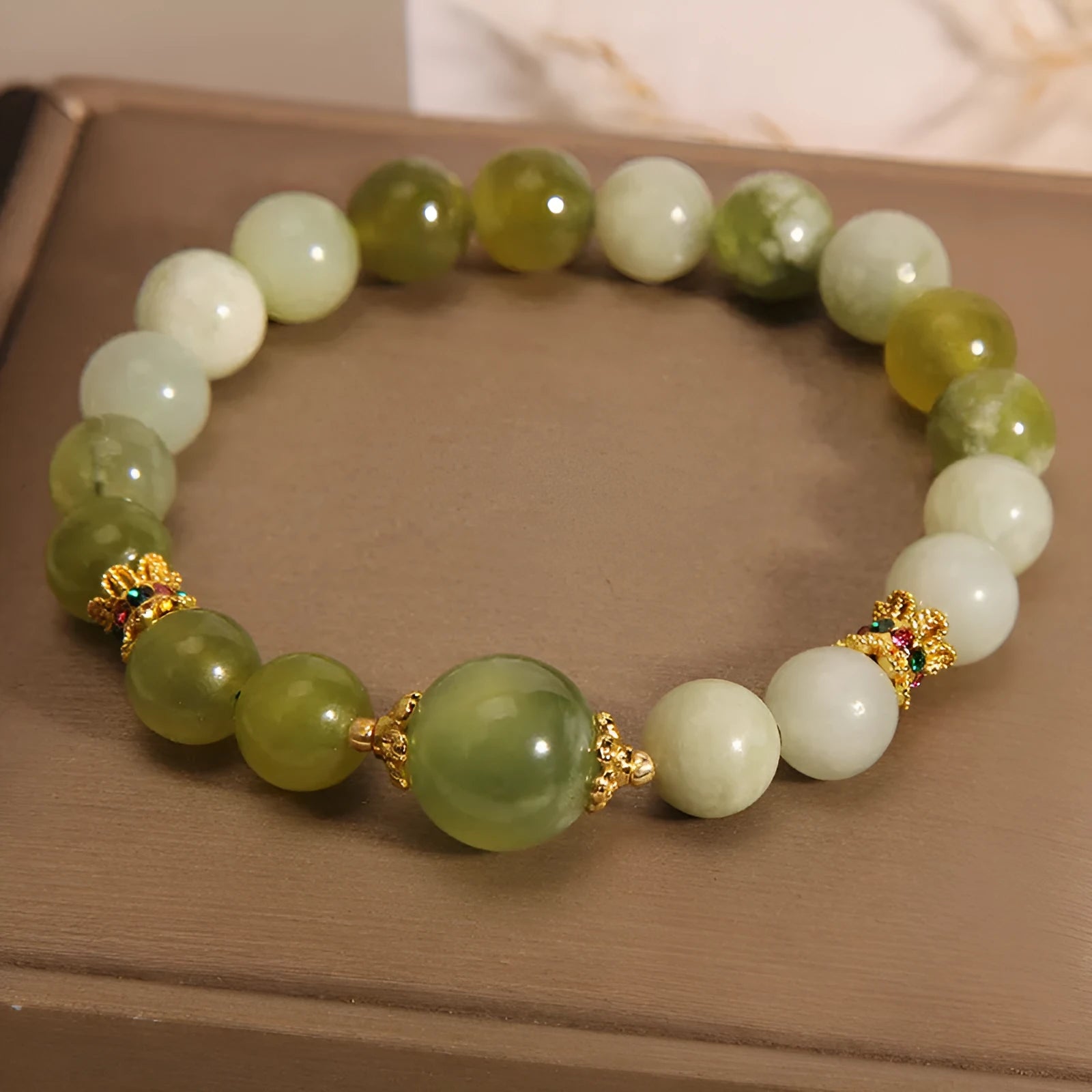 Xiuyan jade green Mori-style women's bracelet on a wrist.