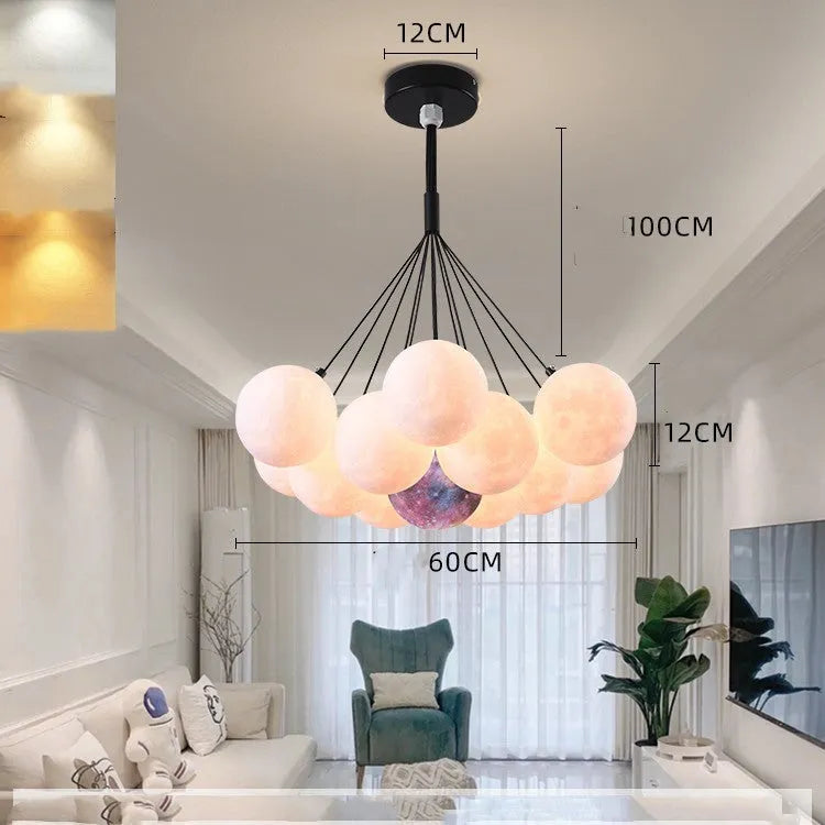 Nordic fish-shaped pendant chandelier with cluster of spherical moon bubble lights in gold or black finish.