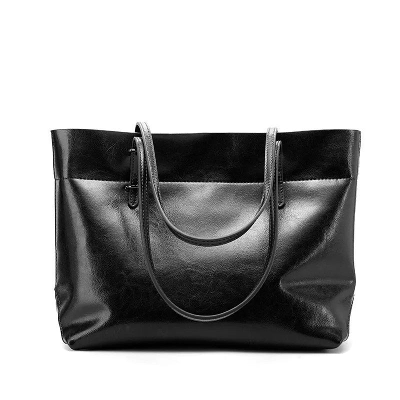 Brown waxed cowhide leather crossbody handbag showing two compartments and phone pocket