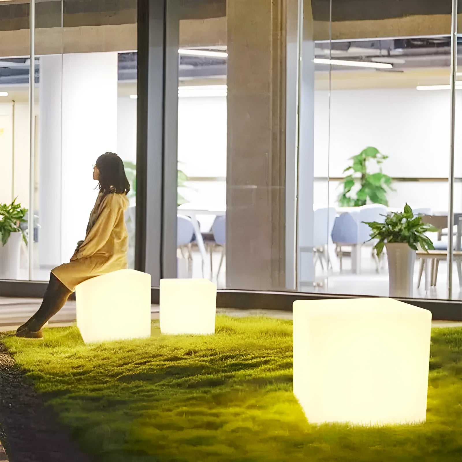 Modern white LED square cube light for outdoor garden and pathway illumination.