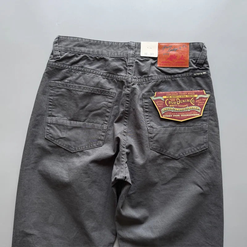 Men's straight-leg cotton casual trousers in khaki colour, laid flat to show mid-waist and straight cut.