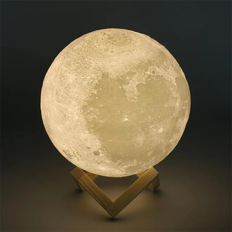 3D printed spherical moon lamp with textured surface on a wooden stand, showing white LED light.