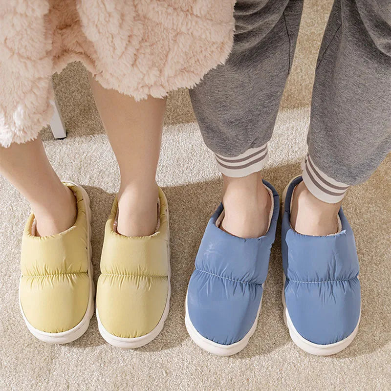 Pair of thick-soled winter slippers with artificial leather upper and plush lining, shown in a choice of colours.