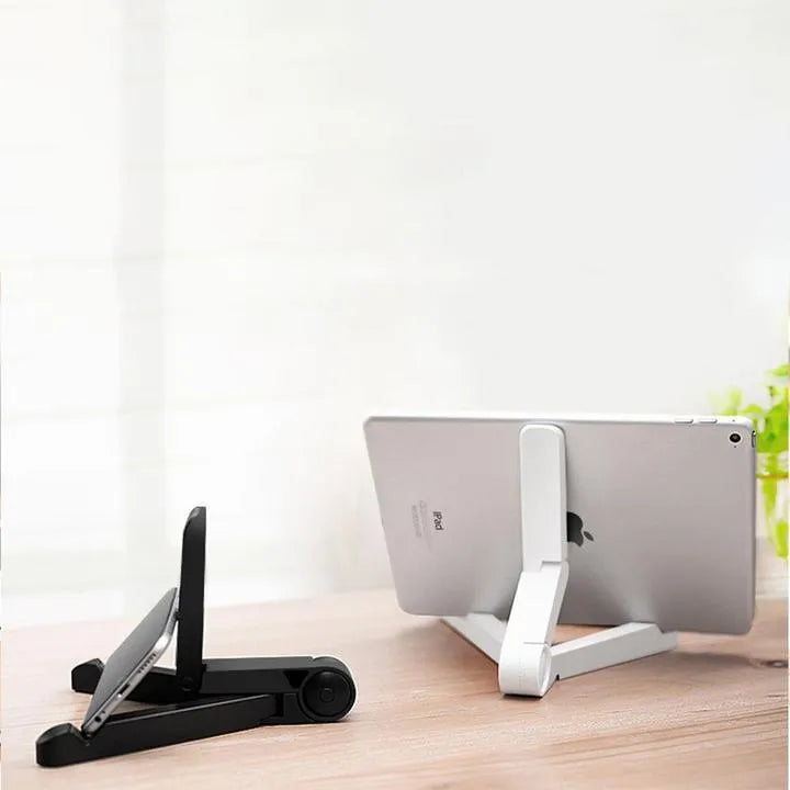 Black foldable tablet holder standing upright with a tablet device resting on its non-slip rubber surface.