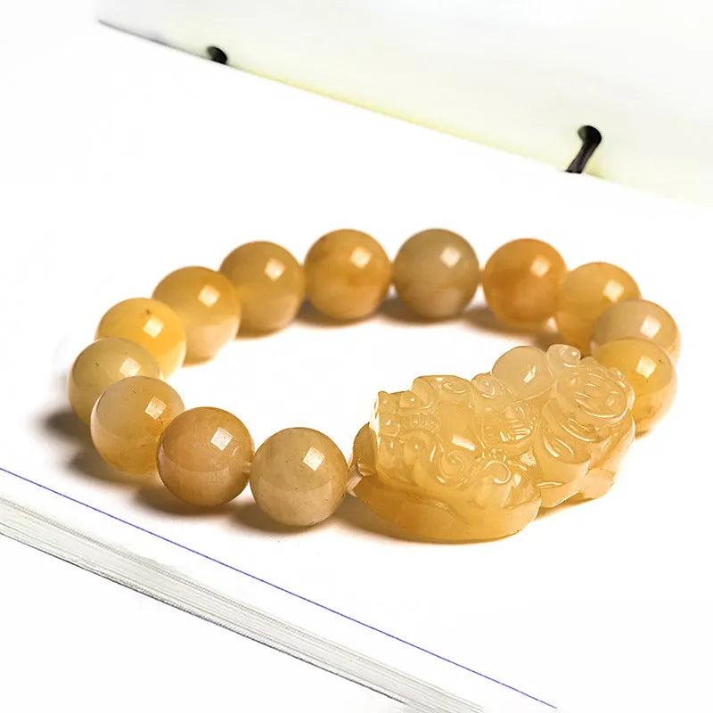 Carved Golden Thread Jinsi Jade bracelet with money motif on adjustable cord, shown in two bead sizes.