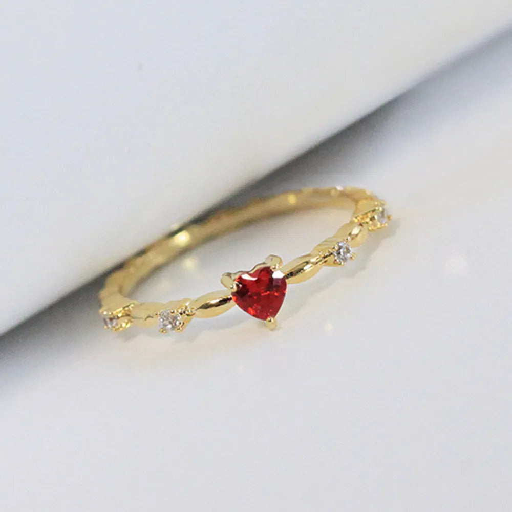 Gold or silver electroplated copper ring with a peach heart shape set with zircon stones.