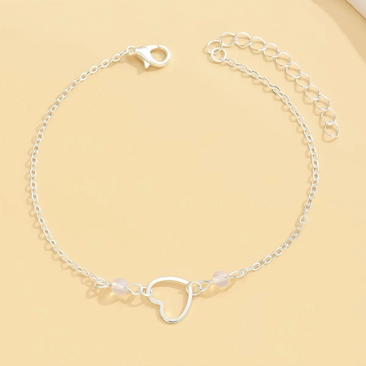 Adjustable women's anklet with heart pendant in gold or silver alloy finish