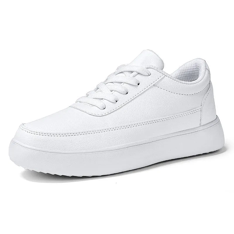 Women's white leather flat casual shoes with lace-up front on a plain background.