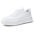 Women's white leather flat casual shoes with lace-up front on a plain background.