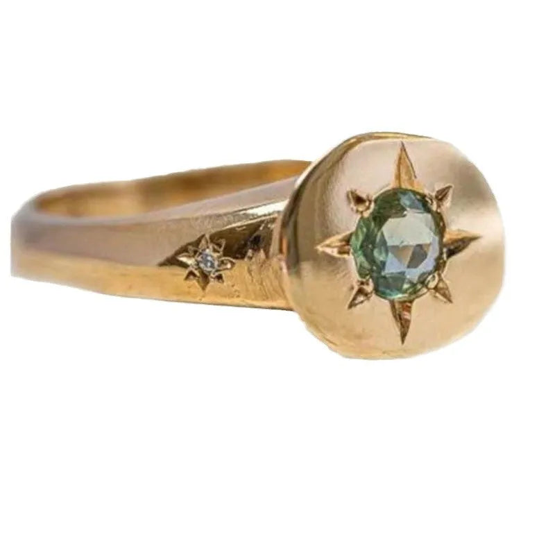 Gold-coloured adjustable ring with a star design and oval zircon stones.