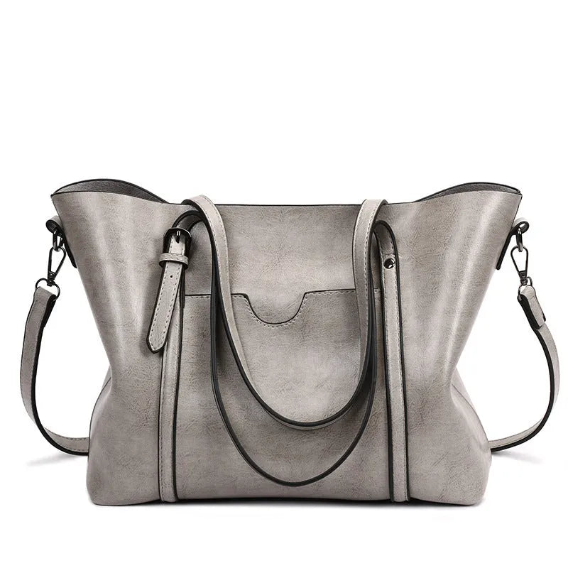 Retro messenger bag for women in multiple colours showing large main compartment and shoulder strap