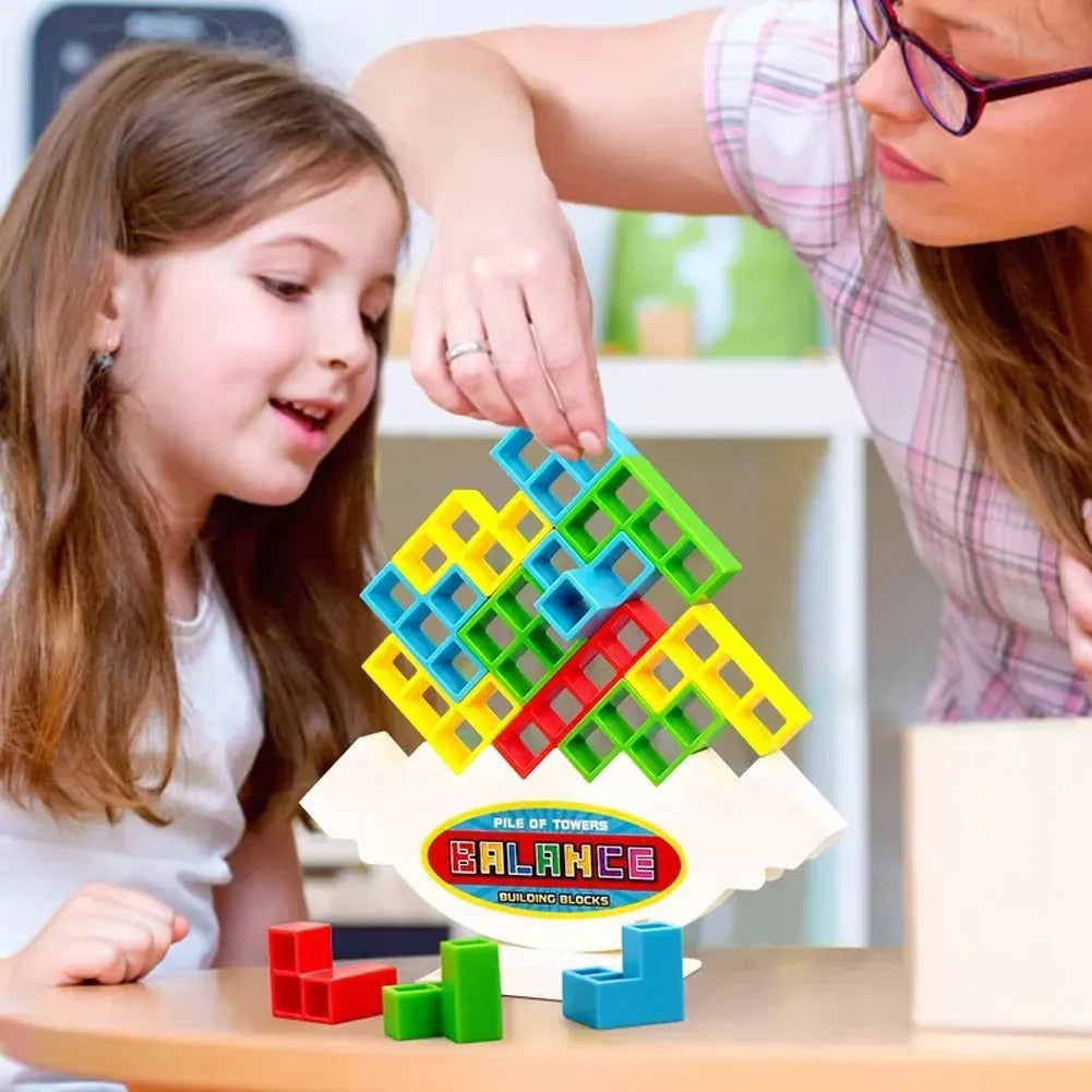 Plastic balance stacking game with 16 coloured blocks, chassis and base on table