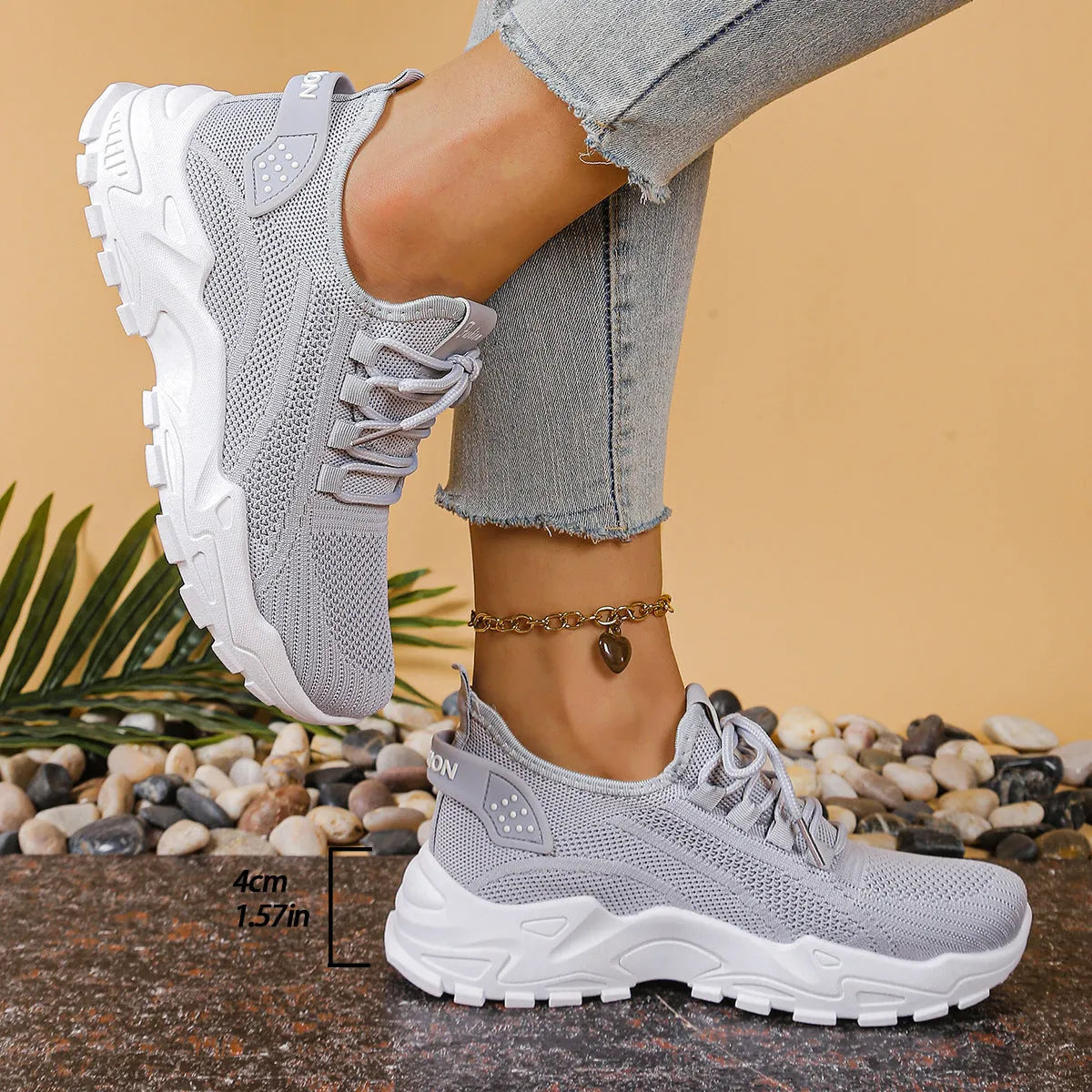 Women's low-top white mesh sports shoes with platform sole and front laces on a grey background.