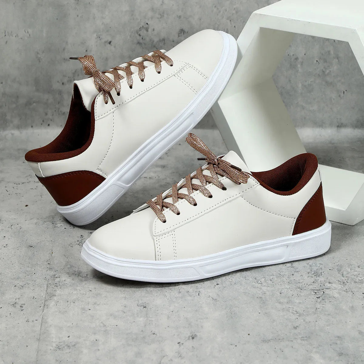 Women's beige brown platform skate sneakers with cross-strap detail and chunky rubber sole.