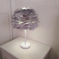 Handmade feather table lamp with metal base, available in white colour, approximately 30cm diameter and 40cm height