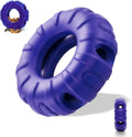 Blue rubber tyre-shaped dog chew toy with oval openings, shown next to dog treats.