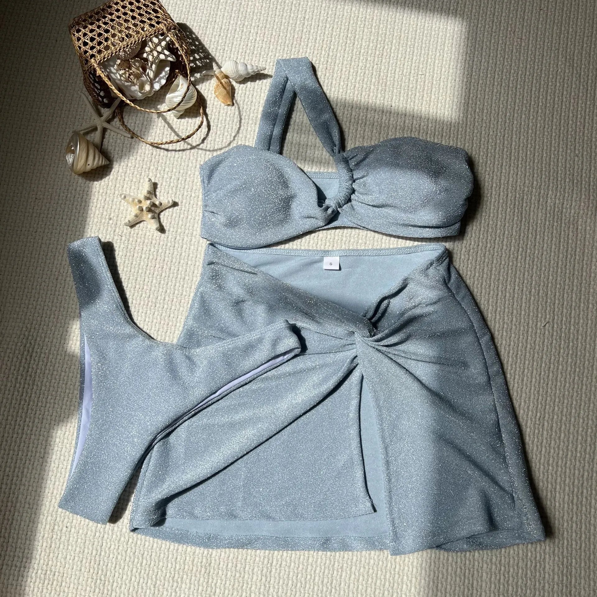 Light green one-shoulder tube top swimsuit set with matching pants and skirt on a mannequin