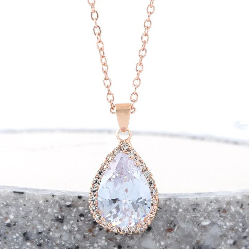 Rose gold water drop shape necklace with rhinestone geometric detailing in pink colour