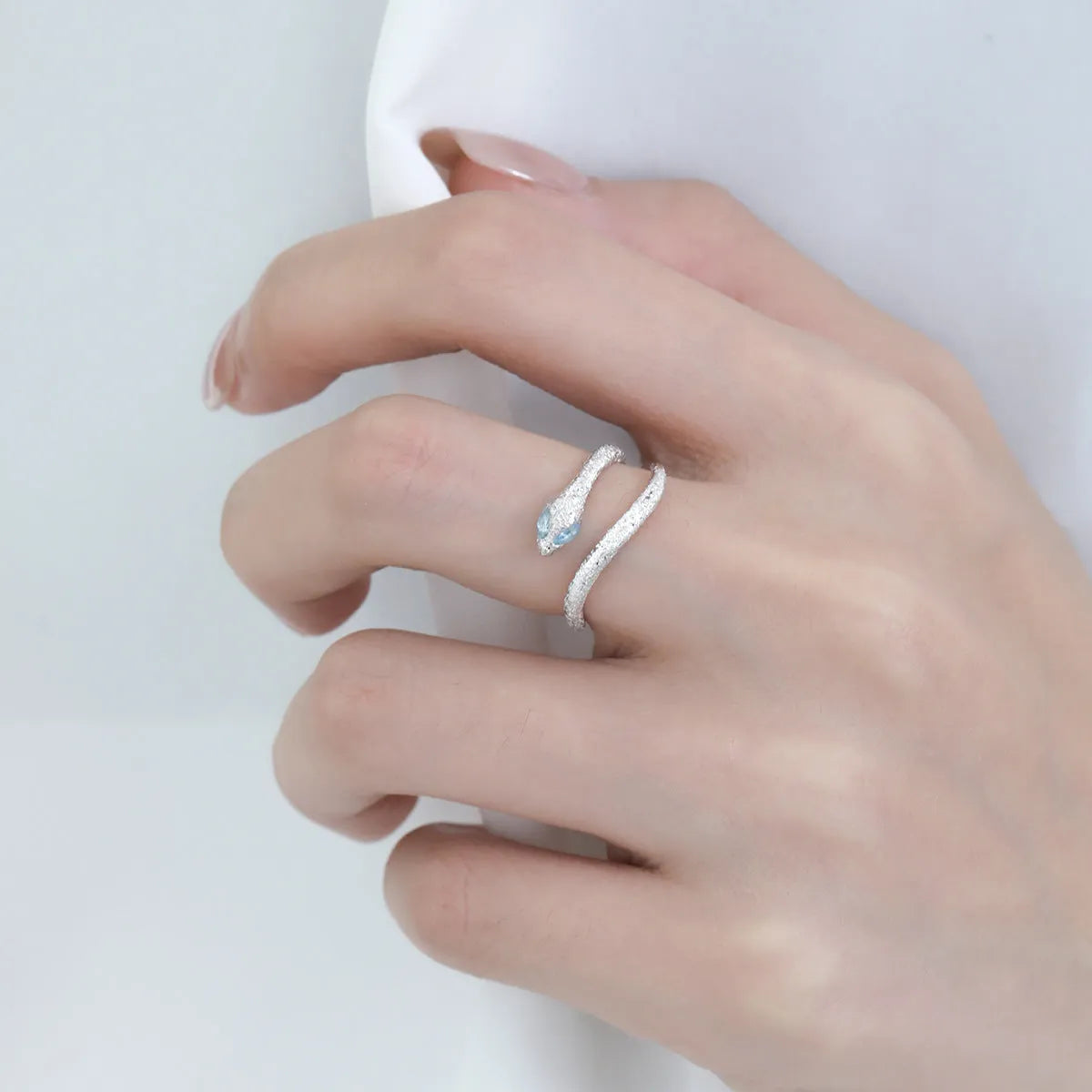 Adjustable silver ring with snake zodiac design electroplated in platinum colour