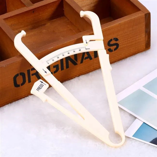 Acrylic body fat caliper with measurement scale showing 0.001mm accuracy