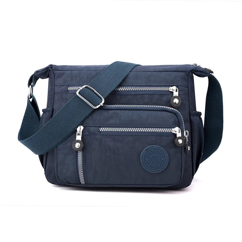 Soft nylon messenger shoulder bag in a choice of five colours including black and blue.