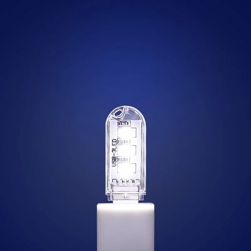 Small white LED baby night light with USB cable showing white and warm light settings