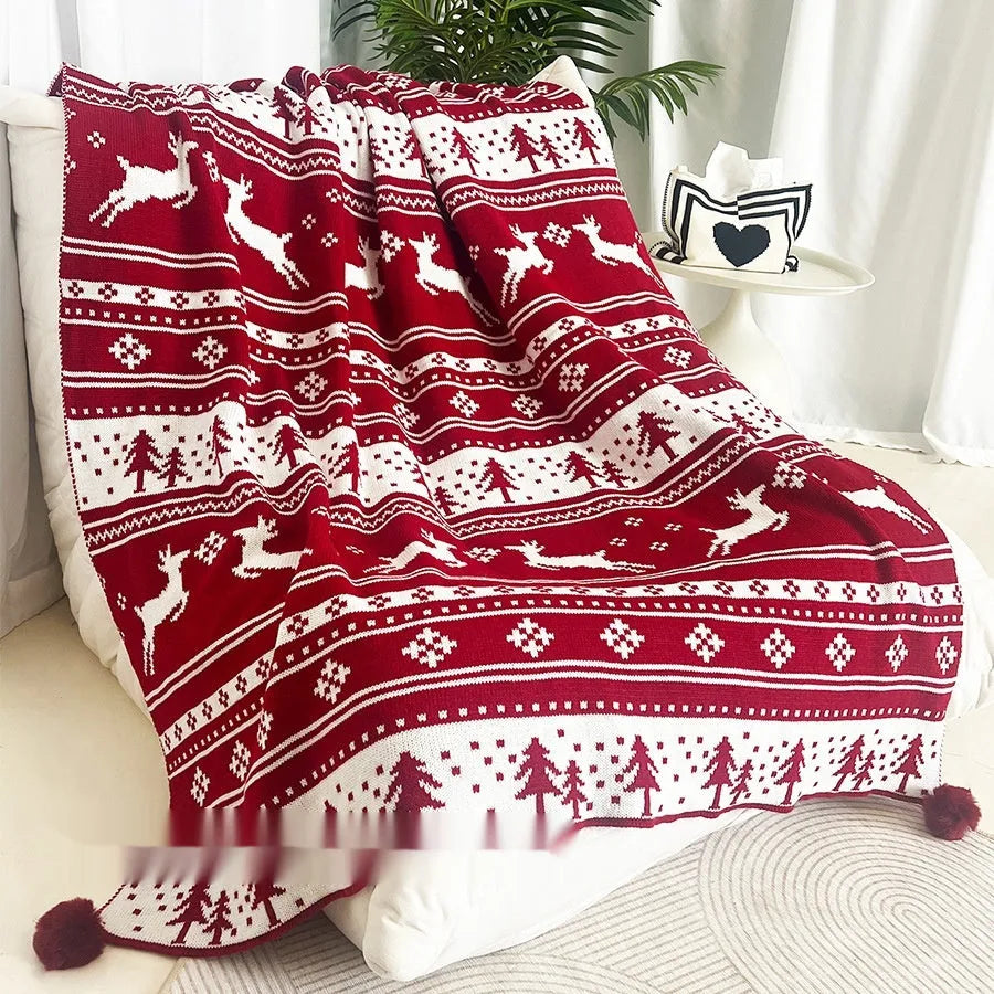 Personalised Christmas acrylic blanket with reindeer or snowflake pattern on a sofa