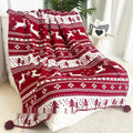Personalised Christmas acrylic blanket with reindeer or snowflake pattern on a sofa