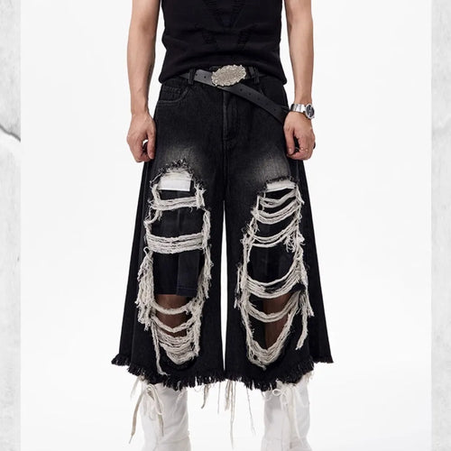 Black women's cropped wide leg jeans with mid-high waist and ripped patch detail