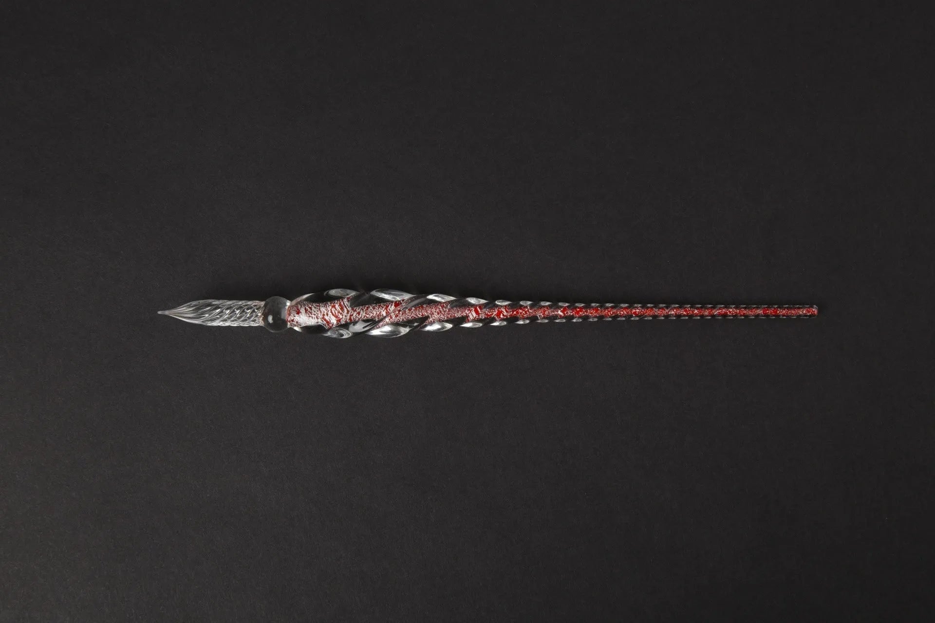 Transparent glass art pen with coloured ink dipped design in a gift box.