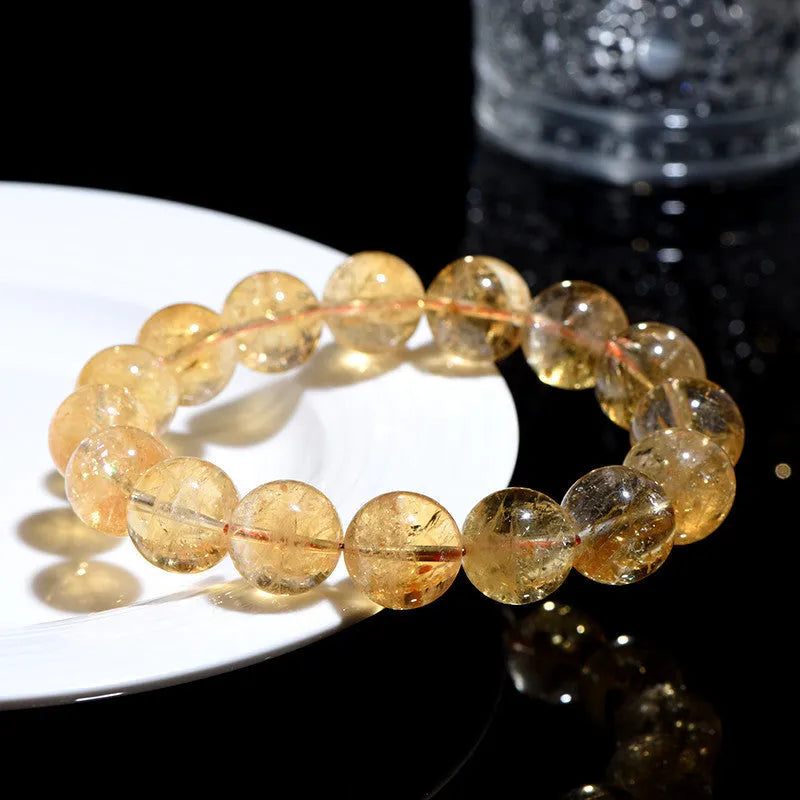 Natural yellow citrine gemstone bracelet showing single circle and three circle bead designs on a wrist.