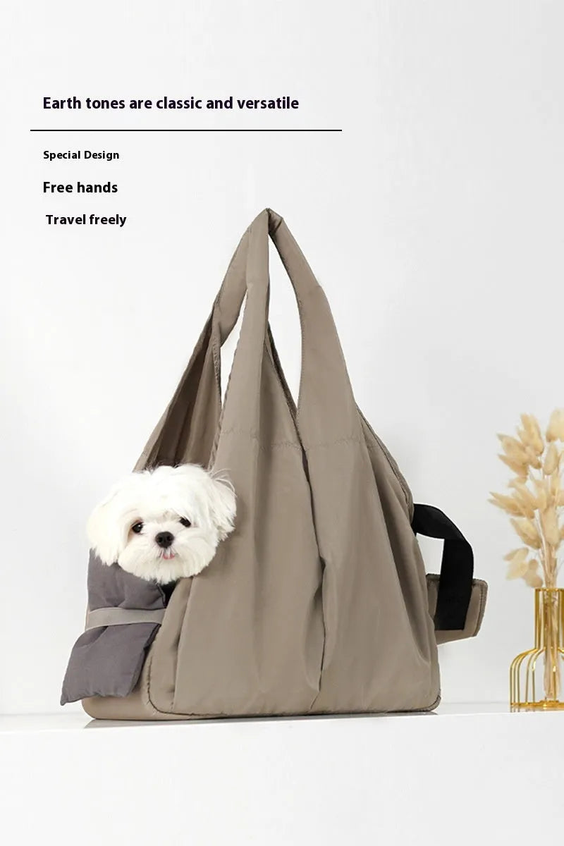 Apricot coloured cloth pet carrier handbag for small dogs or cats, showing carrying handles.