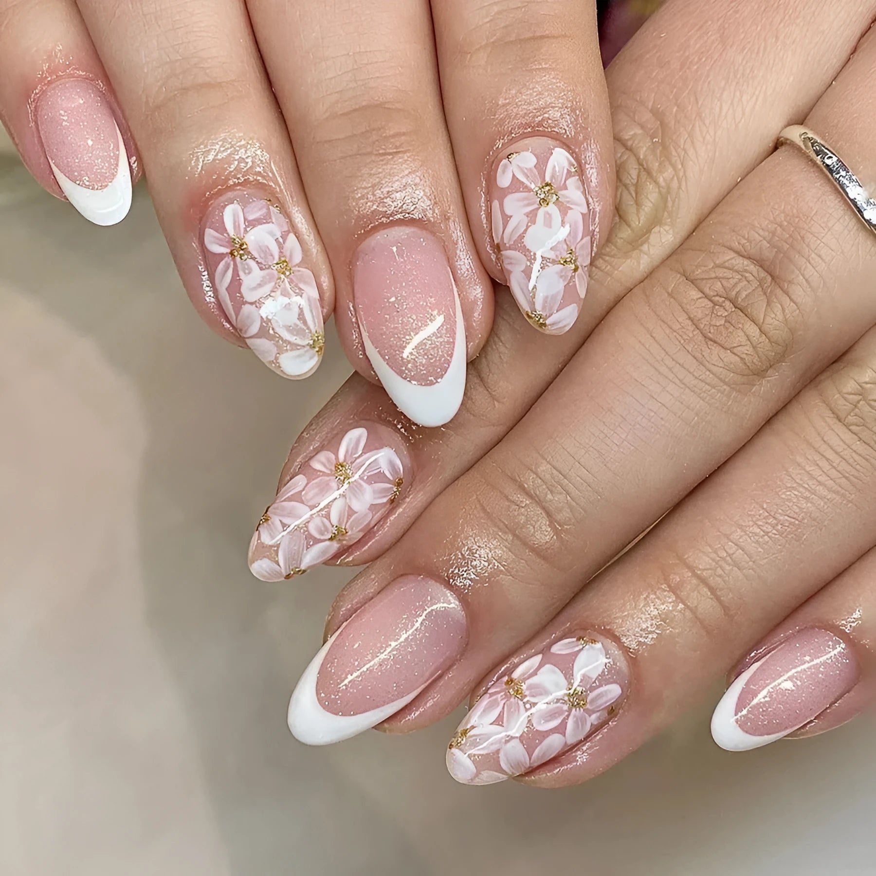 Short almond French manicure press-on nails with glitter flower designs in colour C625