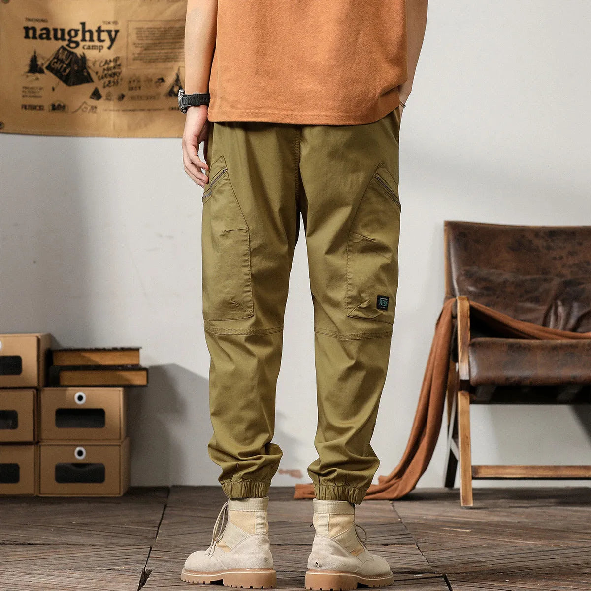 Men's khaki cotton harem pants with tapered ankle bands and a mid-waist zip fly.