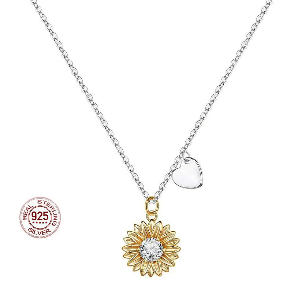 Sterling silver sunflower necklace with geometric daisy petal pendant on an adjustable cross chain.
