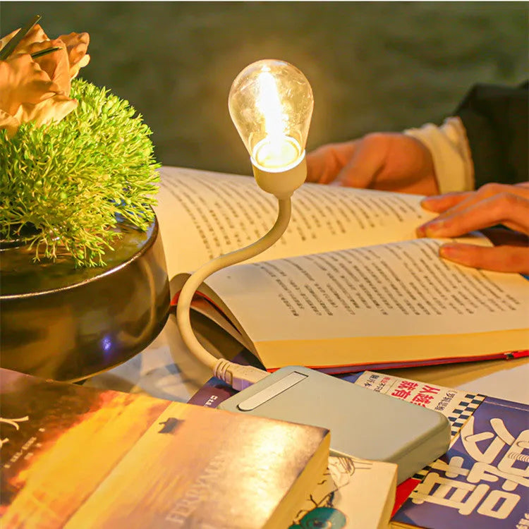 A folding USB rechargeable night light with a glowing tungsten filament S14 LED bulb.