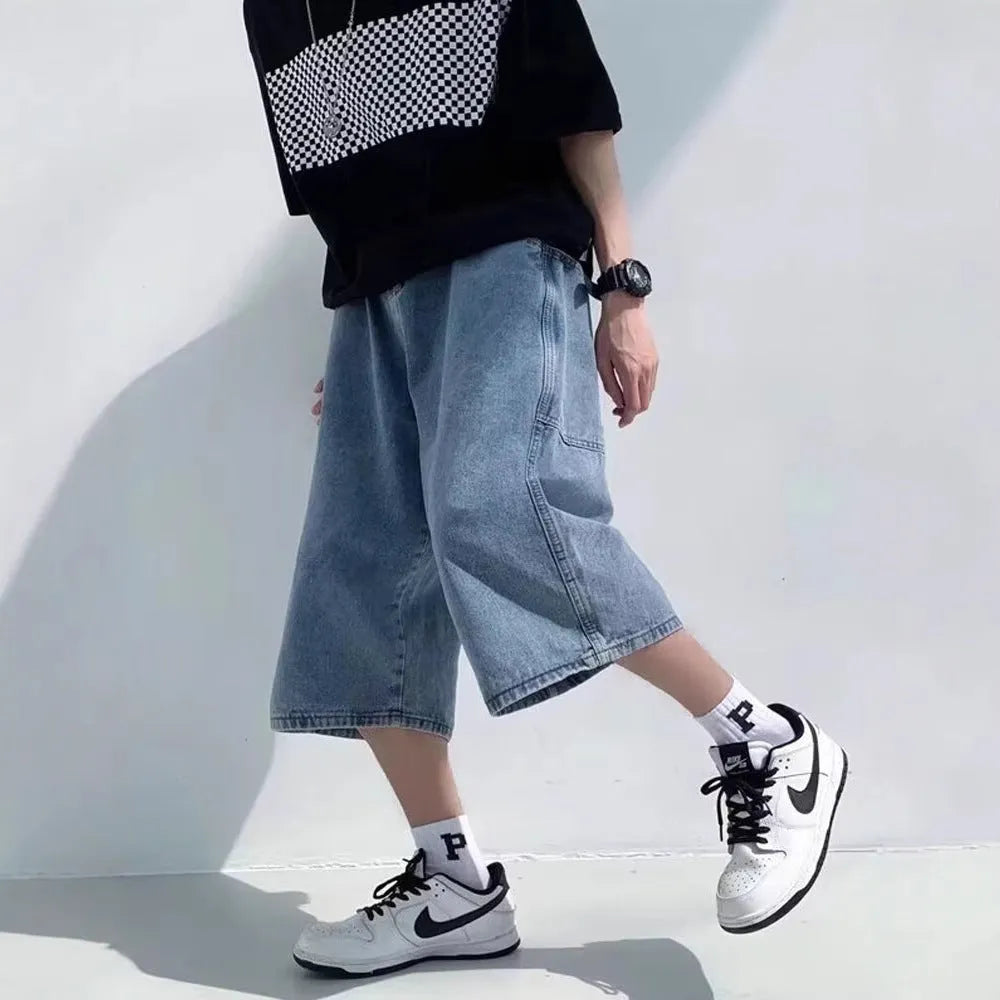 Men's washed blue denim pirate shorts with high waist and cropped length on a plain background.