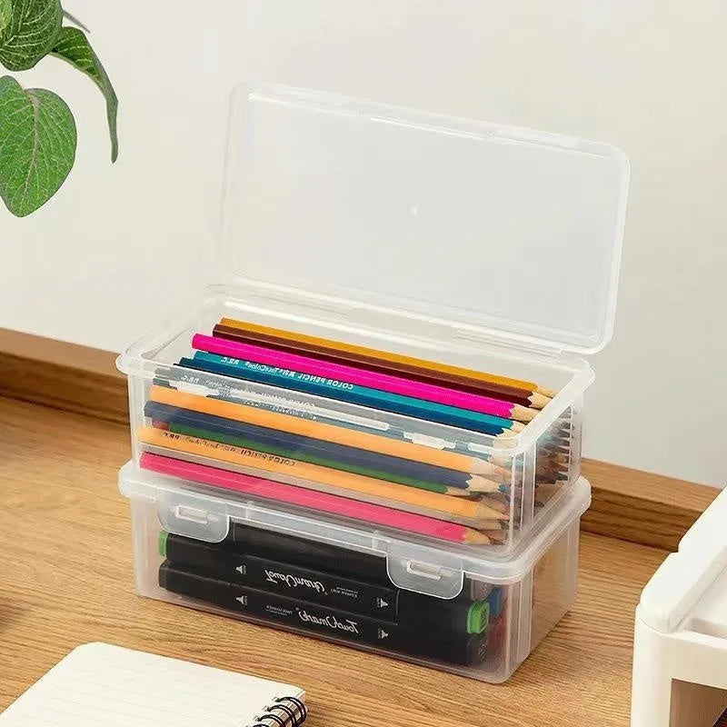Large clear plastic pencil storage box filled with colouring pencils and crayons.