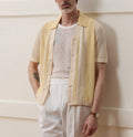 Yellow short-sleeved polo shirt with hollow-out asymmetric design detail on Tencel fabric