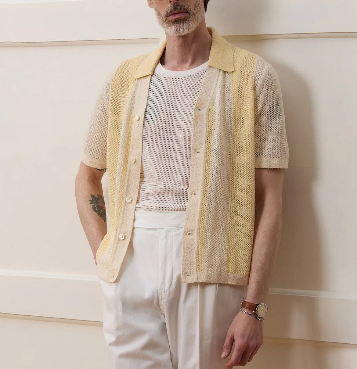 Yellow short-sleeved polo shirt with hollow-out asymmetric design detail on Tencel fabric